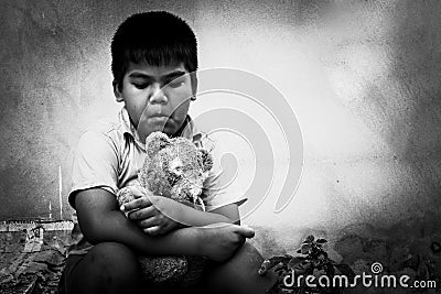 Kid pauper with old teddy bear Stock Photo