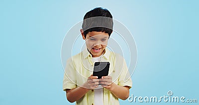 Kid, phone or typing to chat in studio on social media to play mobile games or download app. Blue background, scroll or Stock Photo