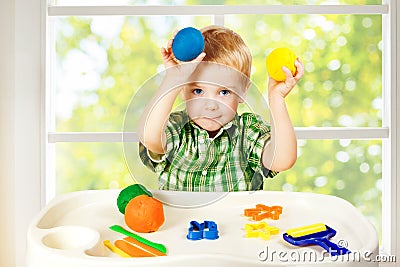 Kid Play Modeling Plasticine, Child and Colorful Clay Dough, Toys Stock Photo