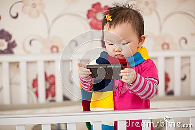 Kid playing cellphone Stock Photo