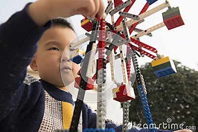 Kid playing lego block Stock Photo