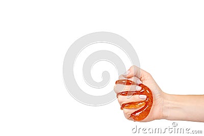 kid playing orange slime with hand, transparent toy Stock Photo