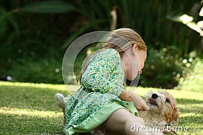 Kid playing with puppy Stock Photo