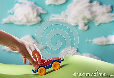 Kid playing with a toy car in handmade world Stock Photo