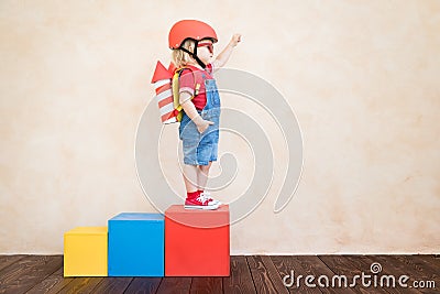 Kid playing with toy rocket at home Stock Photo