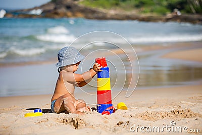 Kid plays with toys at the seashore in summertime Stock Photo