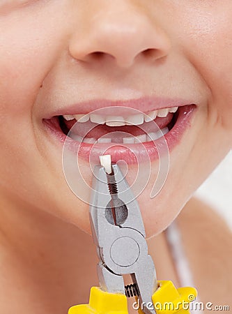 Kid with pliers holding a lost tooth - closeup Stock Photo