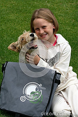 Kid and puppy playing with dreamstime bag Stock Photo