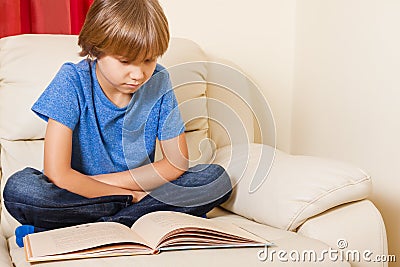 Kid reading a book at home Stock Photo