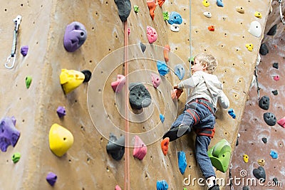 Kid rock climbing Stock Photo