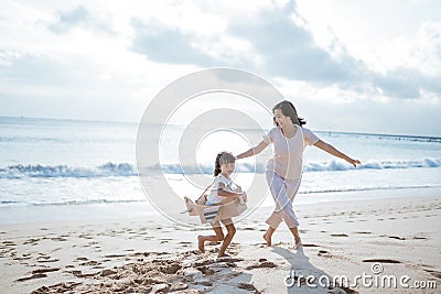 kid running at the beach play with cardboard toy airplane Stock Photo