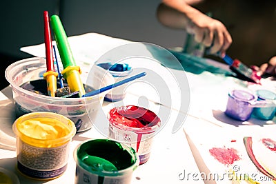 kid's drawing, painting with a brush and hands with color temperas on paper Stock Photo