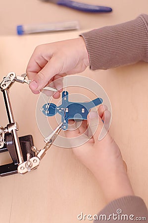 Kid`s hands repairs microchip Stock Photo