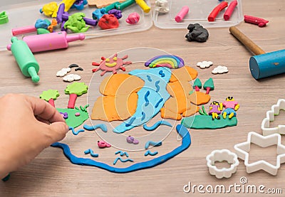 Kid`s playing and creating toys from play dough Stock Photo