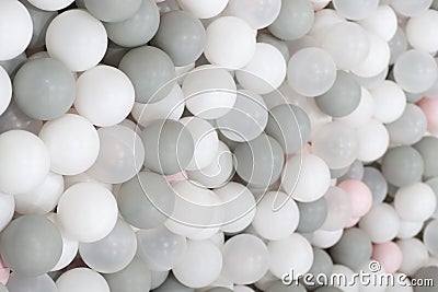 Kid's playing room interior. Pastel color white, grey, pink plastic balls background for baby activity. Copyspace Stock Photo