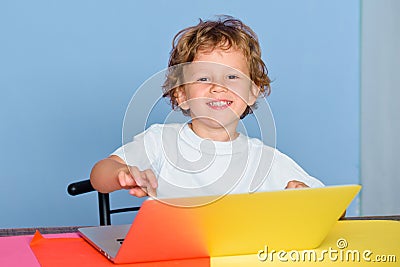 Kid at school with notebook. Child is ready to answer with a blackboard on a background. Funny little child having fun Stock Photo