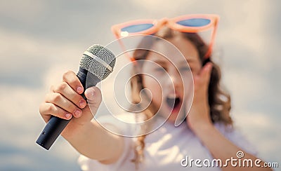 kid sing with mic. selective focus. cheerful event manager. child have fun on party. happy singer with microphone Stock Photo