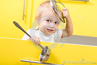 Kid sitting inside yellow opened kitchen box with Stock Photo