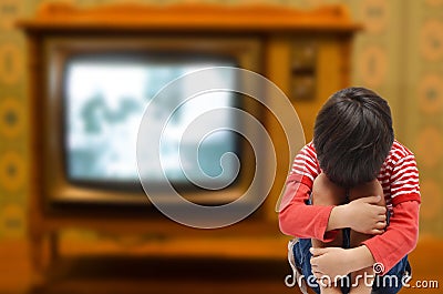 Kid sitting with sadness and sick from tv addict need love from Stock Photo