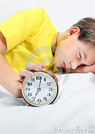 Kid sleep with Alarm Clock Stock Photo