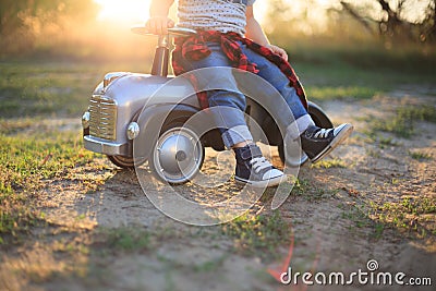 Kid sneakers during car riding in the park Stock Photo