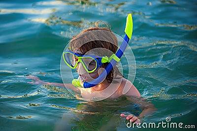 Kid snorkeling in ocean. Diving concept. Child dives into the water. Extreme sport. Kids summer holidays. Stock Photo