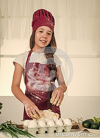 kid soiled in flour in kitchen, chef Stock Photo