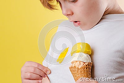 Kid spilling ice cream on white clothes. Clothes ruining. isolated. daily life stain concept Stock Photo
