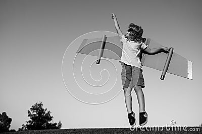 Kid superhero jump anf fly with jetpack. Child pilot play on summer day. Success, leader and winner concept. Imagination Stock Photo