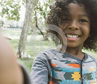 Kid taking selfie in park Stock Photo