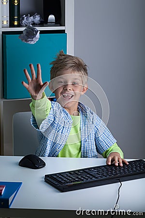 Kid throwing ball of paper Stock Photo