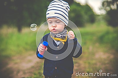 Kid toddler blowing soap bubbles Stock Photo