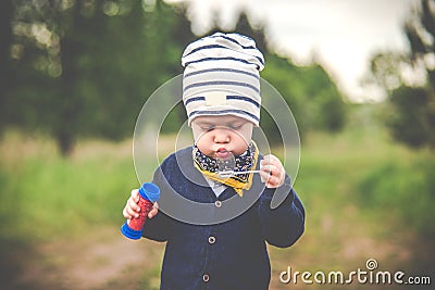 Kid toddler blowing soap bubbles Stock Photo