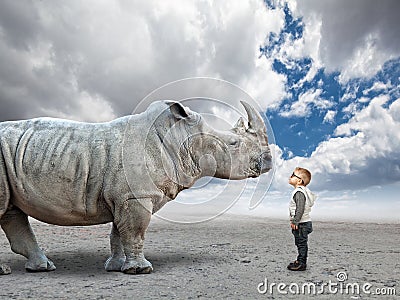 Kid vs rhino Stock Photo