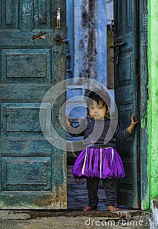 Kid watching colourful People at barsana during Holi Festival,UttarPradesh,India Editorial Stock Photo