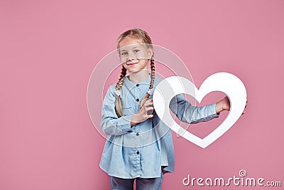 Kid with white heart on pink , St valentines day and mothers day concept Stock Photo