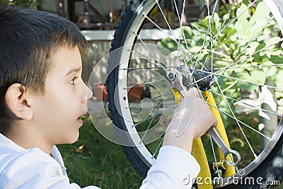 Kid who fix bikes Stock Photo