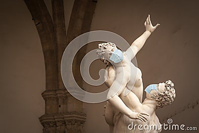 The Kidnapping of the Sabine Women Statue by Giambologna, in the Loggia dei Lanzi in Florence Italy With Face Masks - Coronavirus Editorial Stock Photo