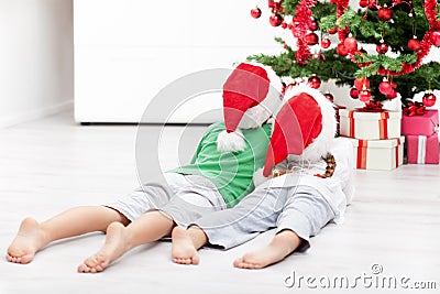 Kids admiring the christmas tree Stock Photo