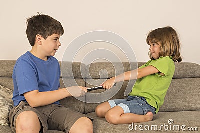 Kids arguing for playing with a digital tablet Stock Photo