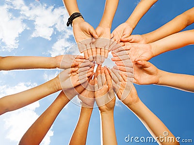Kids arms in circle shape on sky background Stock Photo