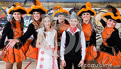 Kids as royal couple of German fasching with uniformed cheerleader dance group Stock Photo