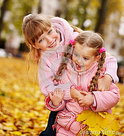 Kids in autumn orange leaves. Stock Photo