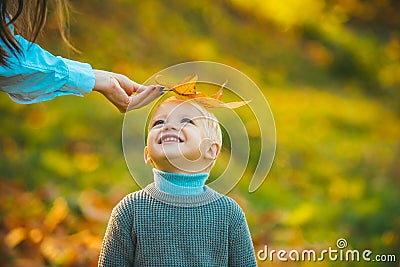 Kids in autumn park on yellow leaf background. Stock Photo