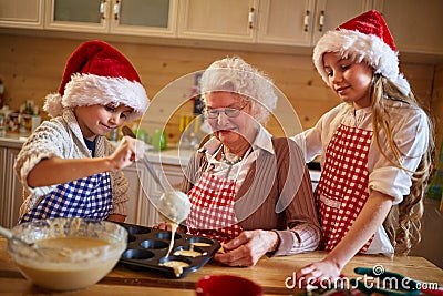 Kids baking cookies with grandmother on xmas Stock Photo