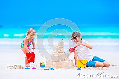 Kids building sand castle on the beach Stock Photo