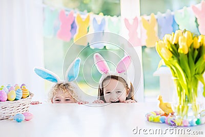 Kids with bunny ears on Easter egg hunt Stock Photo