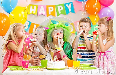 Kids and clown celebrate birthday party Stock Photo