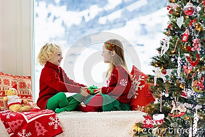 Kids decorate Christmas tree. Child on Xmas eve Stock Photo