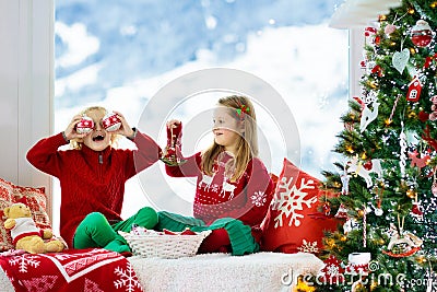 Kids decorate Christmas tree. Child on Xmas eve Stock Photo